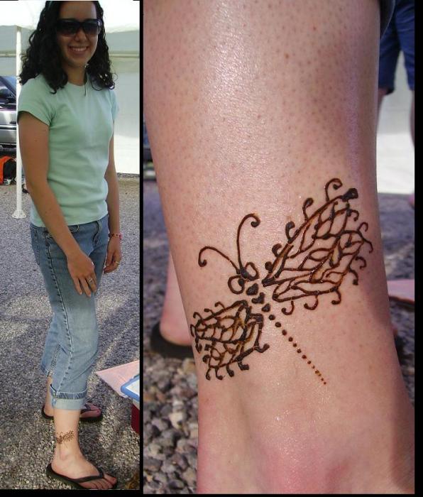 Pretty Celtic dragonfly tattoo surrounded by little flowers.