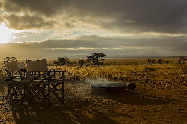 Camp fire and chairs, Tarangire National Park, Tanzania, Africa Photograph by David Fettes