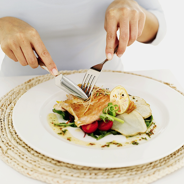 Person Using A Fork And Knife On A Plate Of Grilled Salmon Photograph by Stockbyte Person Using A Fork And Knife On A Plate Of Grilled Salmon Photograph by Stockbyte