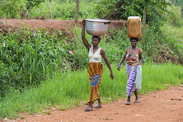Two women carrying goods on their heads, DR Congo Photograph by Guenterguni