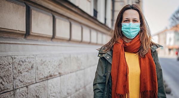 Woman with protective mask on the street in city Photograph by South_agency