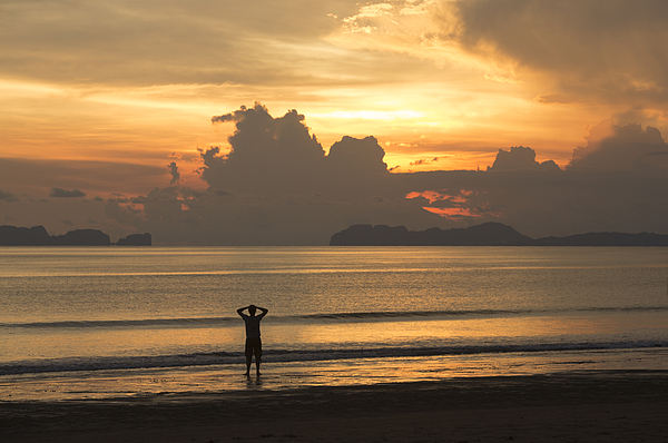 A man watching the sunset in Thailand Photograph by David Trood