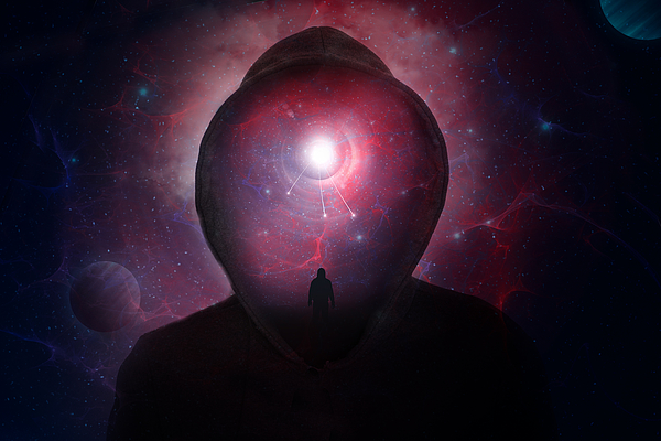 A science fiction concept of a hooded figure without a face. Over layered with a man looking into a universe of stars and planets. Photograph by David Wall