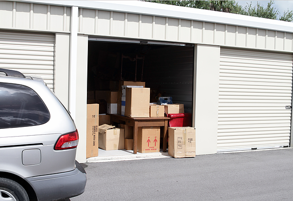 An open self storage unit with a van parked next to it Photograph by NoDerog An open self storage unit with a van parked next to it Photograph by NoDerog