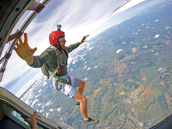 Brave Parachutist with red helmet jump out of the plane Photograph by Mauricio Graiki