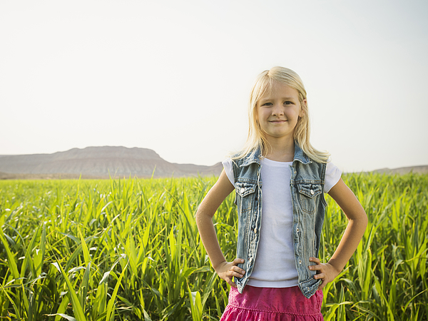 Caucasian girl smiling in corn field Photograph by Erik Isakson