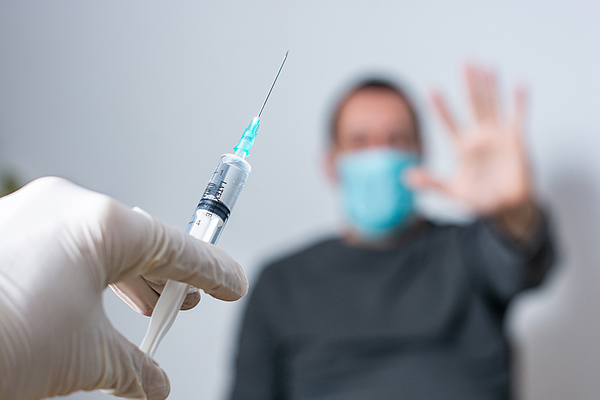 Close up of unrecognizable doctor trying to vaccinate its patient while he is refusing it Photograph by StockPlanets Close up of unrecognizable doctor trying to vaccinate its patient while he is refusing it Photograph by StockPlanets