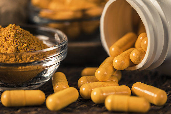 Curcumin Herbal Supplement Capsules and Turmeric Powder Photograph by Microgen