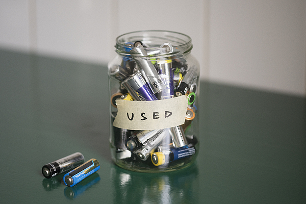 High angle view of batteries in glass jar with USED label on table Photograph by Halfdark