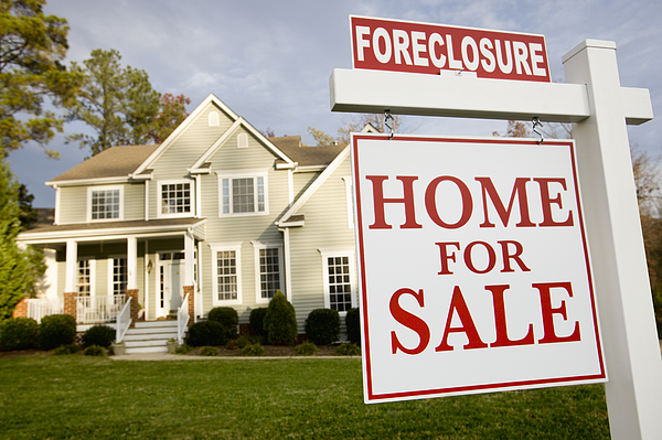 Home with foreclosure sign in front yard Photograph by Ariel Skelley