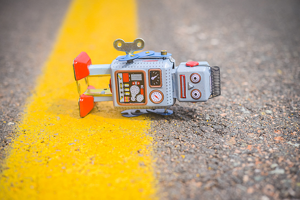 Retro robot fallen on the road Photograph by Benoitb