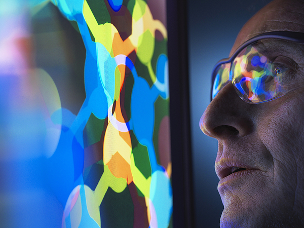 Scientist understanding the design of a molecular structure on computer screen in laboratory Photograph by Andrew Brookes Scientist understanding the design of a molecular structure on computer screen in laboratory Photograph by Andrew Brookes