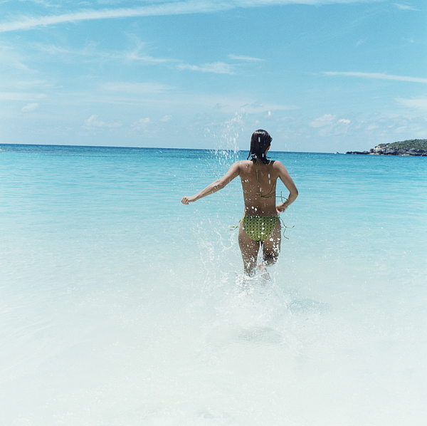 Woman Splashing in Ocean Photograph by Dana Tezarr