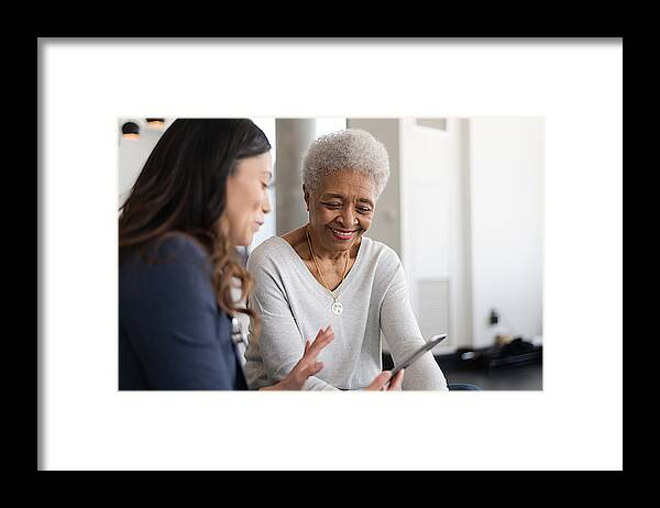 Expertise Framed Print featuring the photograph Young doctor with elderly patient by FatCamera