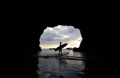 Beach Royalty-Free and Rights-Managed Images - Surfer Inside A Cave At Muriwai New by Deddeda