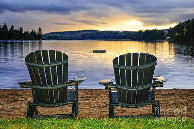 Beach Royalty-Free and Rights-Managed Images - Wooden chairs at sunset on beach 2 by Elena Elisseeva