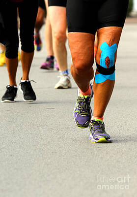 Athletes Photos - athlete with knee bandaged by medical bandage during the Maratho by Fed Cand