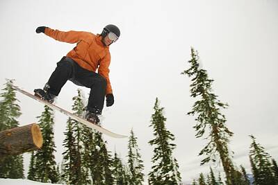 Celebrities Royalty-Free and Rights-Managed Images - Snowboarder In Mid Air by Leah Hammond