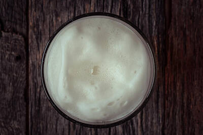 Cities Rights Managed Images - Top View of Foam on a Pint of Beer Royalty-Free Image by Brandon Bourdages