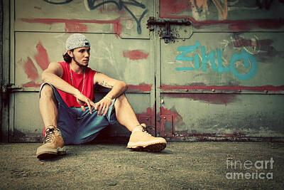Mannequin Dresses Rights Managed Images - Young man sitting Grunge graffiti wall Royalty-Free Image by Michal Bednarek