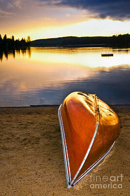 Beach Royalty-Free and Rights-Managed Images - Lake sunset with canoe on beach 3 by Elena Elisseeva