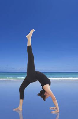 Athletes Royalty-Free and Rights-Managed Images - Woman doing yoga on the beach by Setsiri Silapasuwanchai
