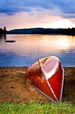 Beach Royalty-Free and Rights-Managed Images - Lake sunset with canoe on beach 1 by Elena Elisseeva