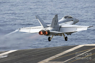 Politicians Photos - An Fa-18f Super Hornet Launches by Stocktrek Images