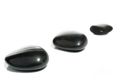 Just Desserts - Three black pebbles by Richard Thomas