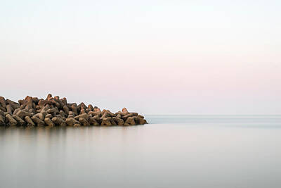 Modern Man Famous Athletes - Beautiful calm landscape of rocky outcrop into calm sea by Matthew Gibson