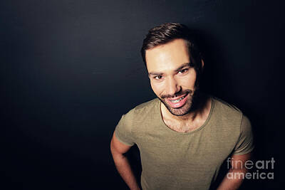 Athletes Photos - Attractive, smiling man standing next to a wall. by Michal Bednarek