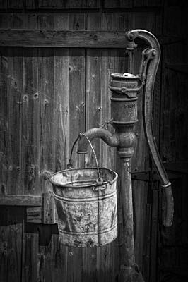 Randall Nyhof Royalty Free Images - Black and White Still Life of Rusty Water Pump with Bucket Royalty-Free Image by Randall Nyhof