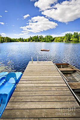 Transportation Photos - Dock on lake in summer cottage country by Elena Elisseeva