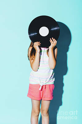 Musicians Photos - Little girl holding a vinyl disc against her head. by Michal Bednarek