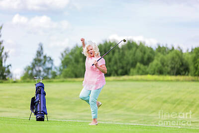 Sports Photos - Mature woman jumping with success on a golf course. by Michal Bednarek