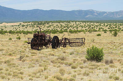 Halloween Mood Rights Managed Images - Old tractor and rake in New Mexico Royalty-Free Image by Jeff Swan