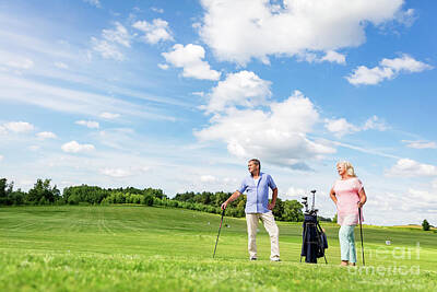 Sports Photos - Senior couple enjoying golf game. by Michal Bednarek