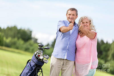 Sports Photos - Senior couple showing OK sign on a golf course. by Michal Bednarek