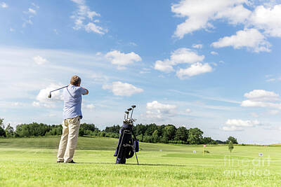 Sports Photos - Senior fit man hitting a golf ball. by Michal Bednarek