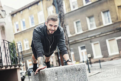 Athletes Photos - Smiling man exercising outside. by Michal Bednarek