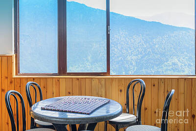 Winter Animals - Table, chairs and window with view of mountain outside. by Rudra Narayan Mitra