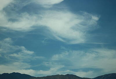 Creative Charisma Rights Managed Images - Whispy Clouds Over Dark Mountain Tops Royalty-Free Image by Colleen Cornelius