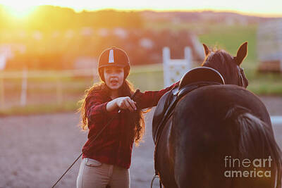 Animals Photos - Young girl getting her horse ready for riding in the padlock. by Michal Bednarek