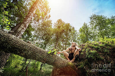 Athletes Photos - Young man sitting on a tree trunk in the forest. by Michal Bednarek
