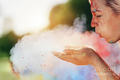 Urban Abstracts - Young woman blowing colorful powder from her hands. by Michal Bednarek
