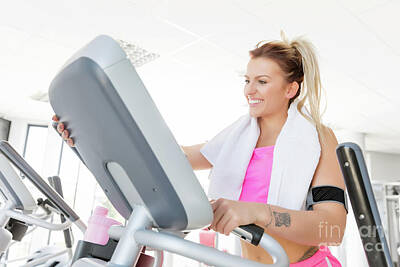 Athletes Photos - Young woman starts treadmill running. by Michal Bednarek