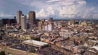 Discover Inventions - The Sun Peaks out through storm clouds lighting downtown New Orl by Christopher Boswell