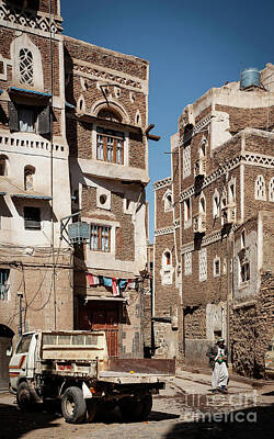 Animals And Earth Rights Managed Images - Street Scene And Buildings In Old Town Of Sanaa Yemen Royalty-Free Image by JM Travel Photography