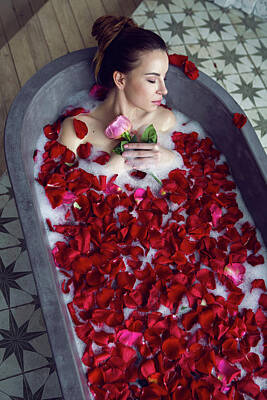 Nighttime Street Photography Rights Managed Images - Beautiful Girl Lying In A Stone Bath With Rose Petals And Foam Royalty-Free Image by Elena Saulich