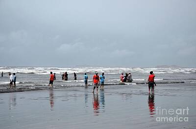 Bath Time - People and families wade in water and enjoy the waves at Sea View beach Karachi Pakistan by Imran Ahmed